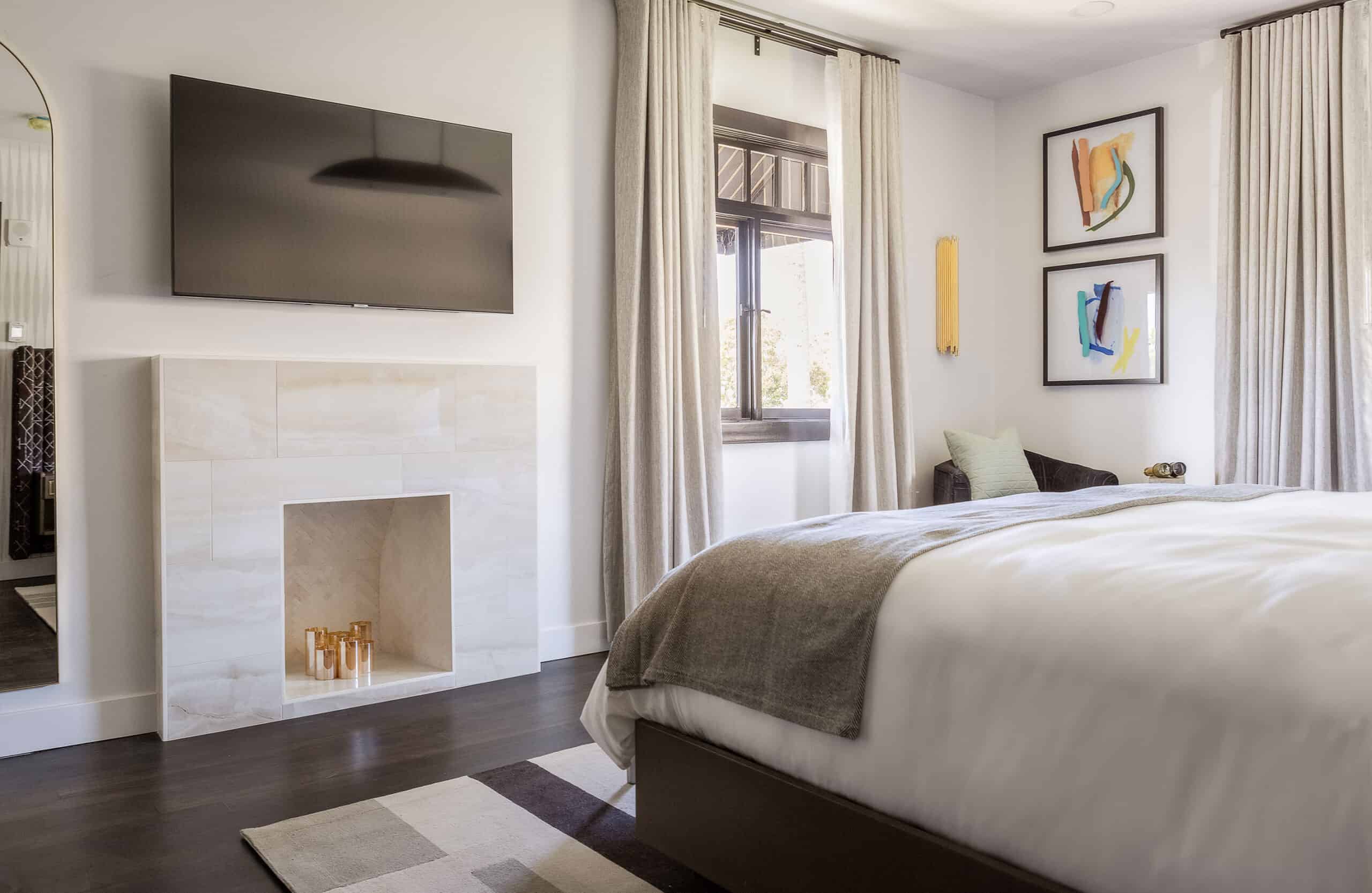 TV, window and paintings inside of The Bluff hotel room at Orli La Jolla boutique hotel