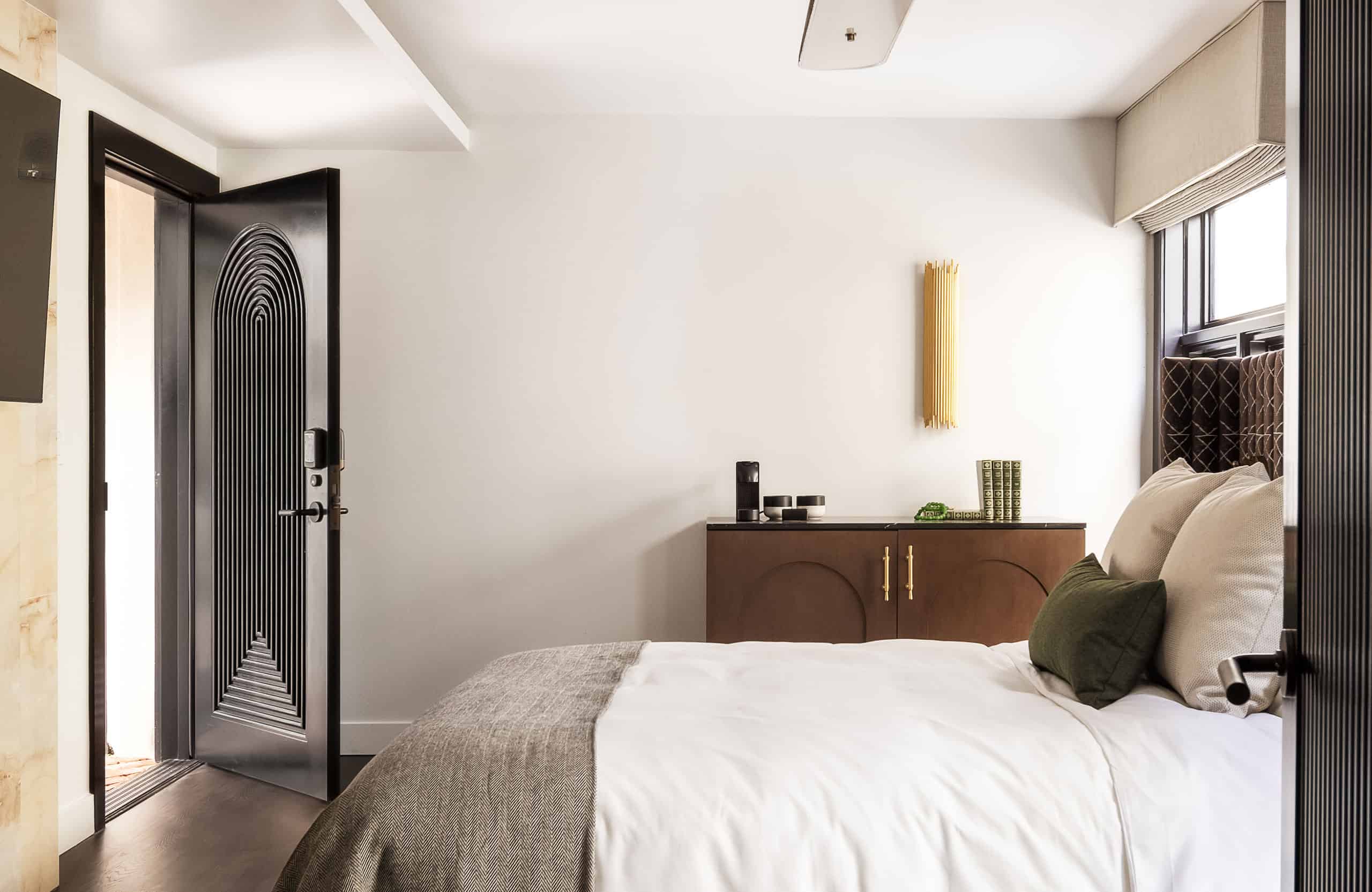 Bed inside of The Nook hotel room at Orli La Jolla boutique hotel