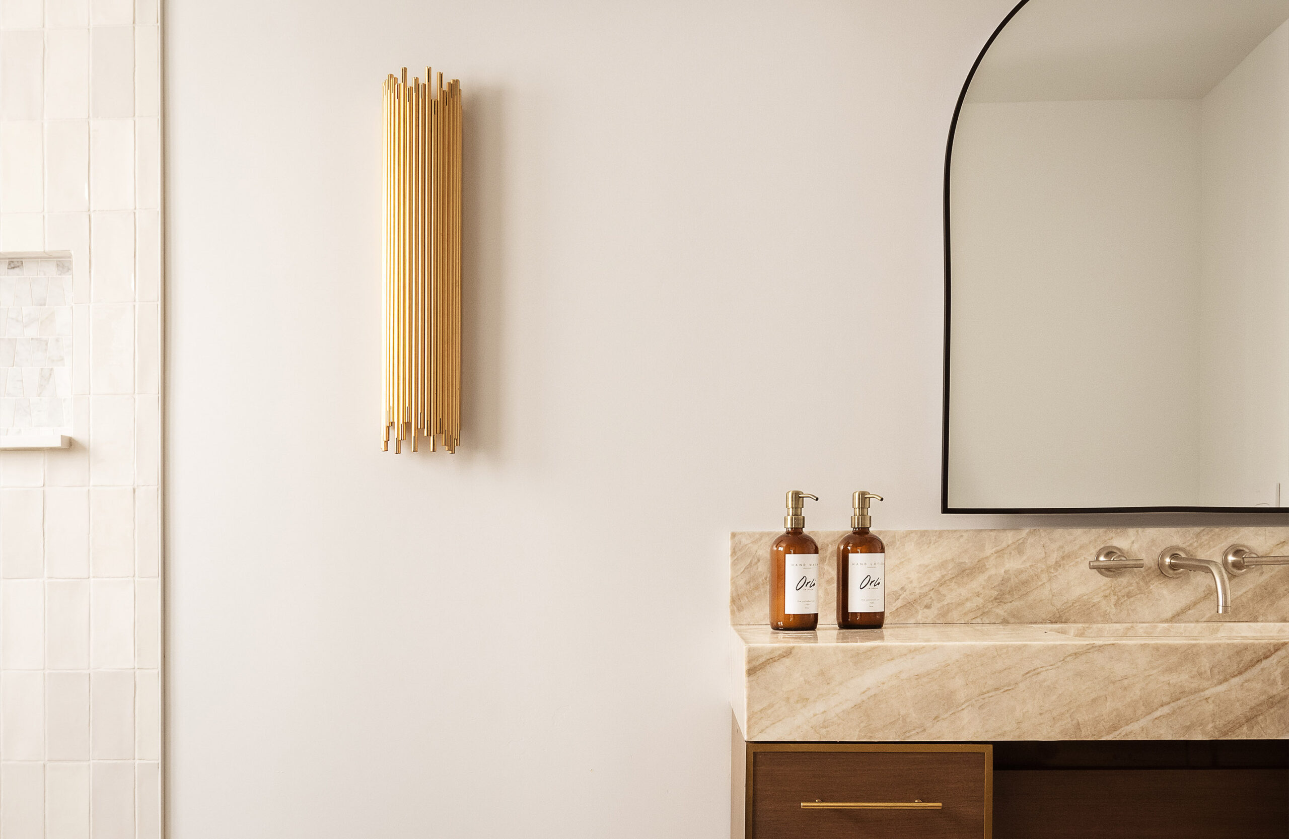 Sink and lamp in the bathroom of The Nook hotel room at Orli La Jolla boutique hotel