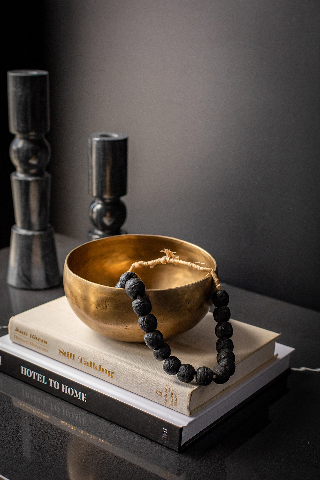 Stack of books and bowl inside of The Irving Gill Penthouse at Orli La Jolla boutique hotel
