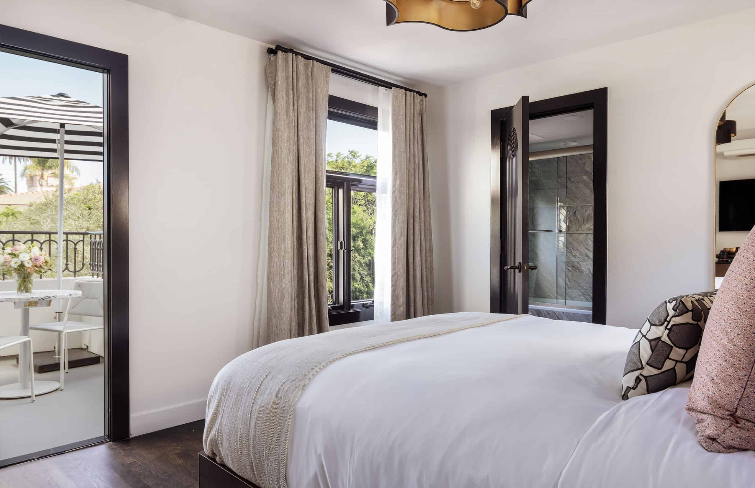 Bed and view inside of The Sunset Suite at Orli La Jolla boutique hotel