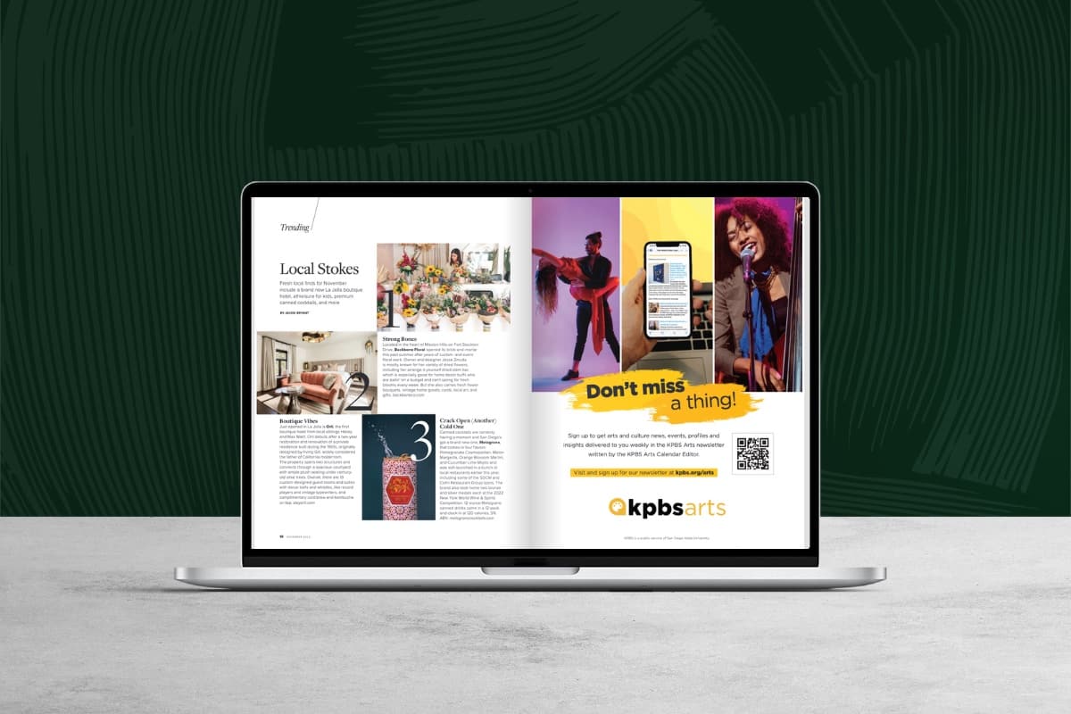 Laptop displaying a digital magazine spread with lifestyle images, editorial text, and a promotional advertisement.