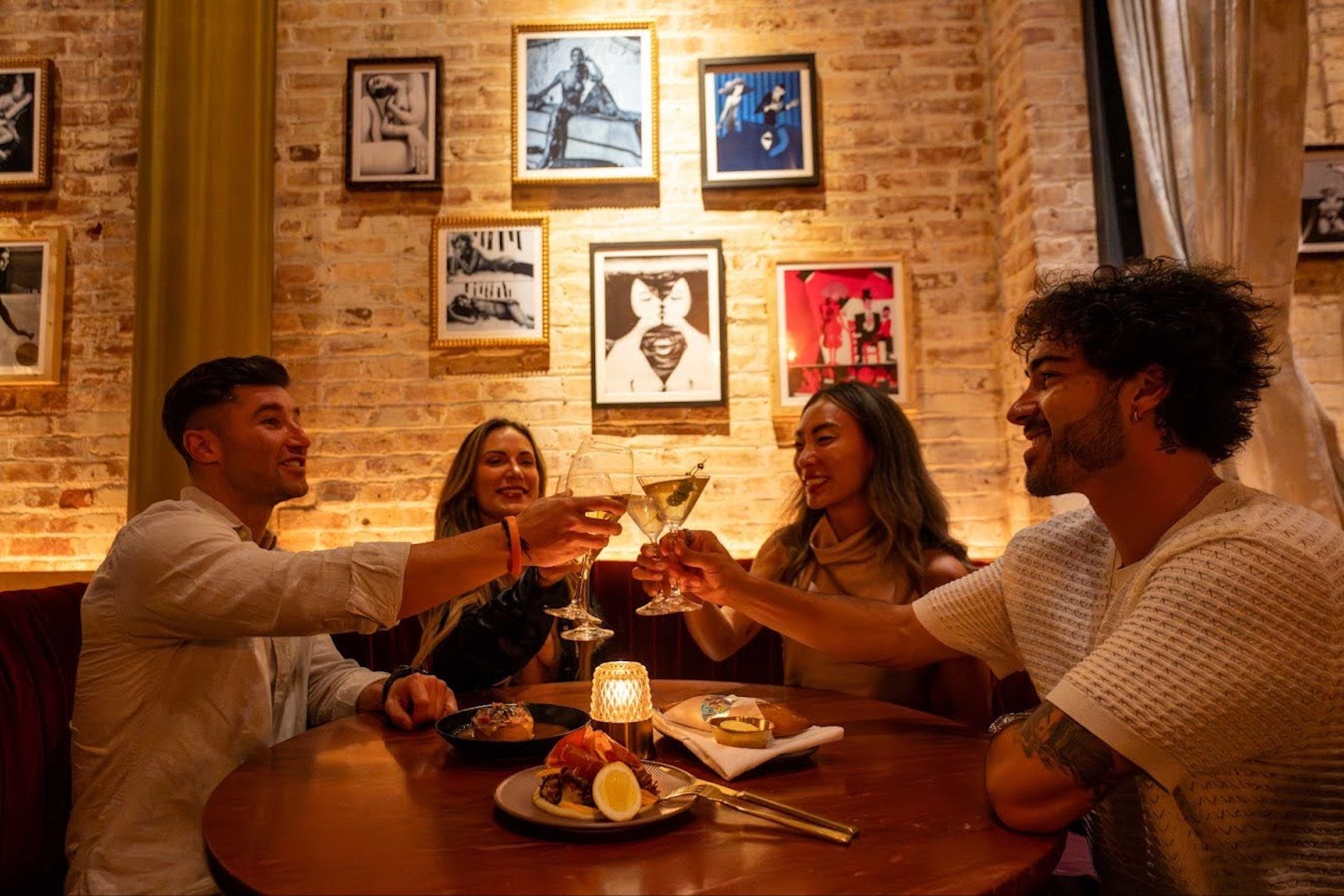 A lively toast among friends—warm light, good drinks, and even better company.