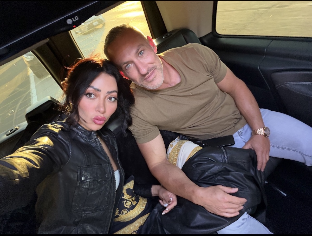 image3 Couple taking a selfie while seated together in the back of a car.